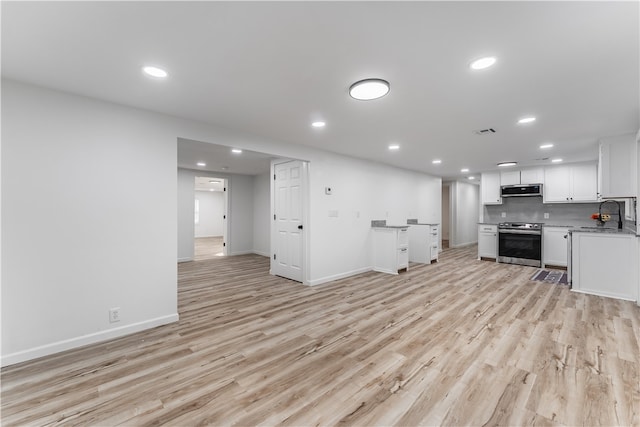 unfurnished living room with light hardwood / wood-style floors and sink