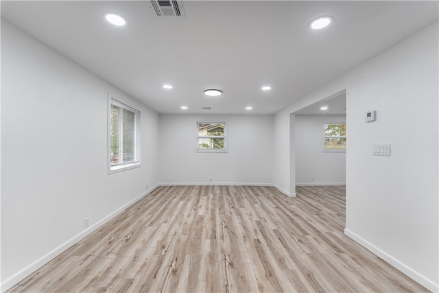 empty room featuring a wealth of natural light and light hardwood / wood-style flooring