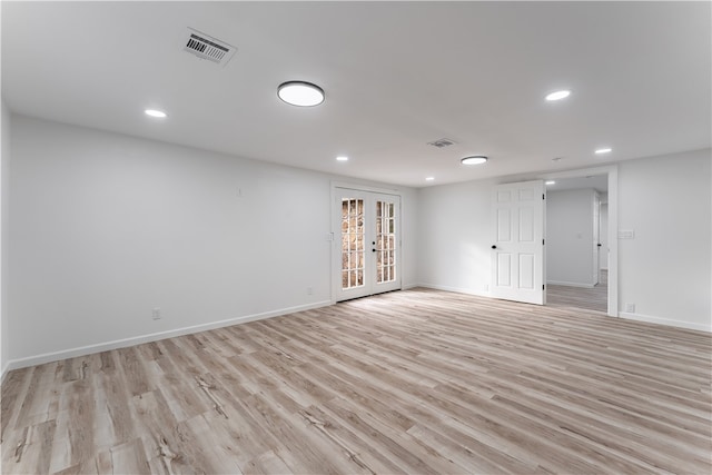 spare room with light wood-type flooring and french doors