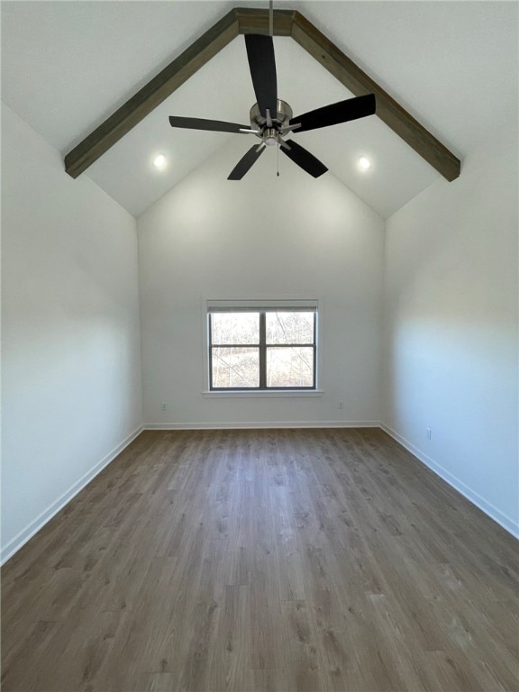 spare room featuring vaulted ceiling with beams, ceiling fan, and wood-type flooring