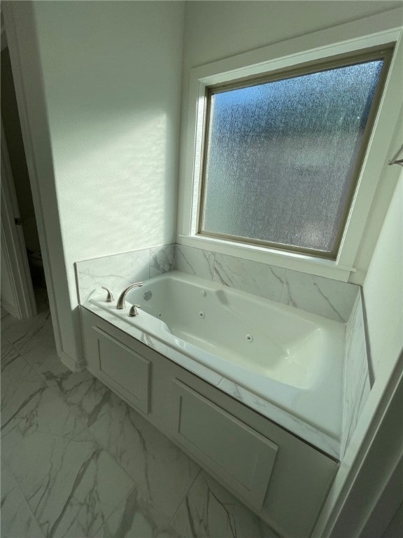 bathroom with a tub to relax in