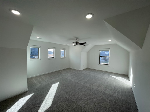 bonus room featuring carpet flooring, vaulted ceiling, a wealth of natural light, and ceiling fan