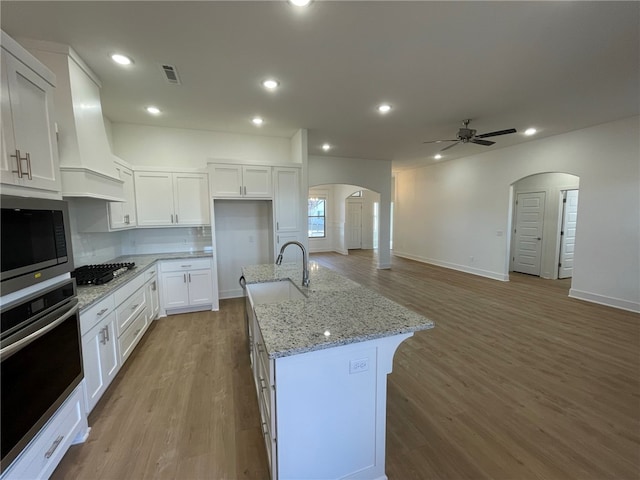 kitchen with sink, white cabinetry, an island with sink, and appliances with stainless steel finishes