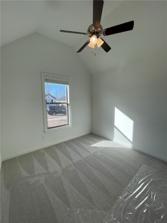 additional living space with carpet flooring, ceiling fan, and vaulted ceiling