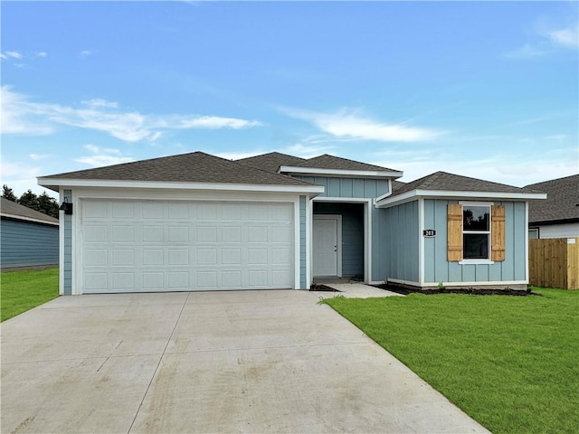 view of front of property featuring a garage and a front yard