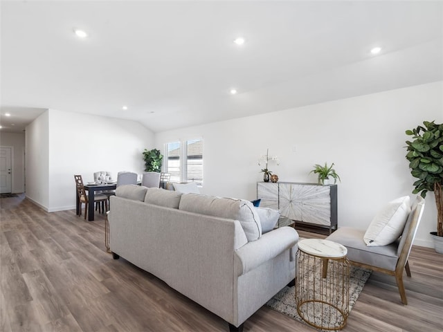 living room featuring hardwood / wood-style flooring and vaulted ceiling