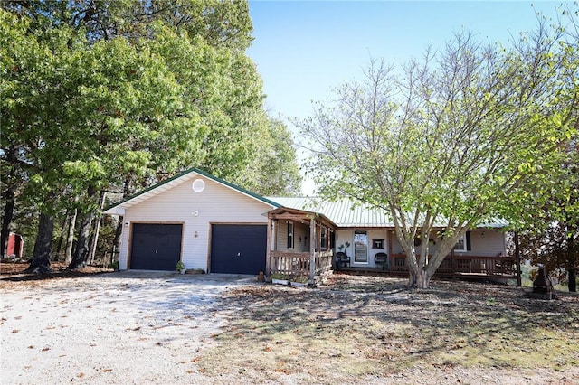 view of front of property with covered porch and a garage