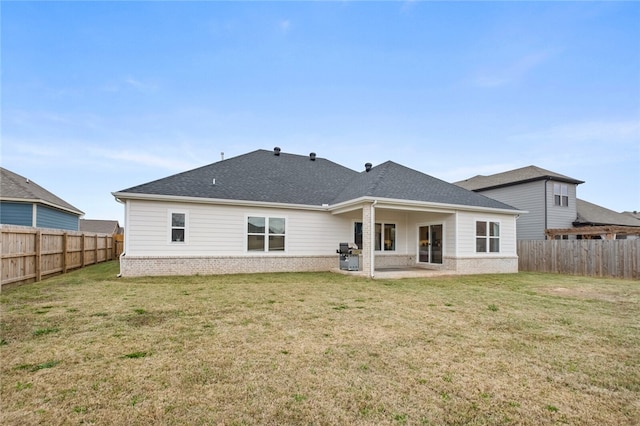 rear view of property featuring a lawn and a patio