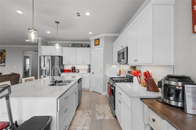 kitchen with pendant lighting, a breakfast bar, sink, and stainless steel appliances