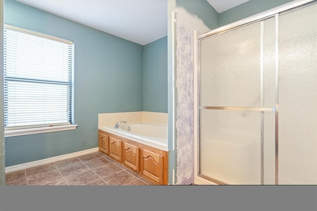 bathroom featuring tile patterned floors and independent shower and bath