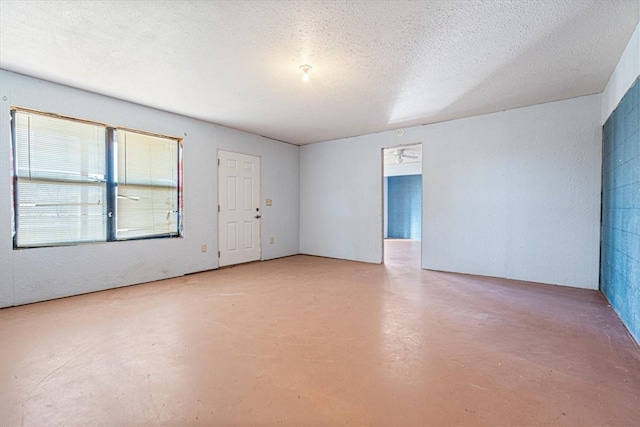 empty room featuring concrete floors and a textured ceiling