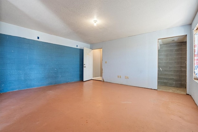 interior space featuring concrete floors and a textured ceiling