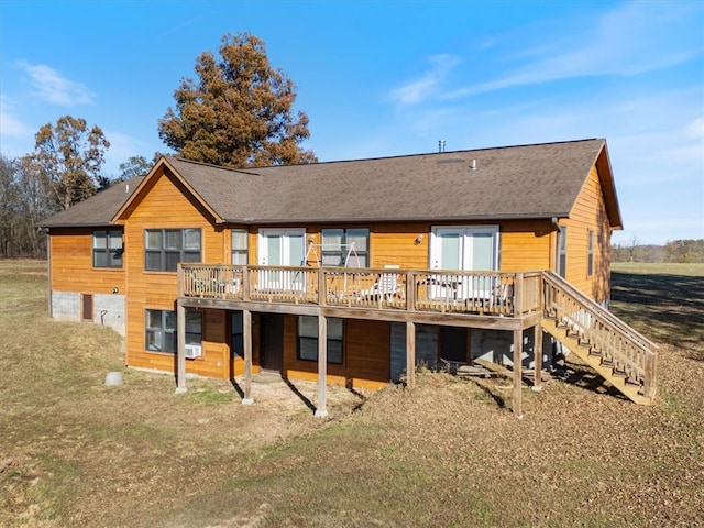 rear view of property with a yard and a deck