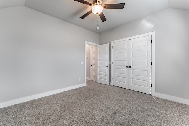 unfurnished bedroom with ceiling fan, a closet, carpet floors, and vaulted ceiling