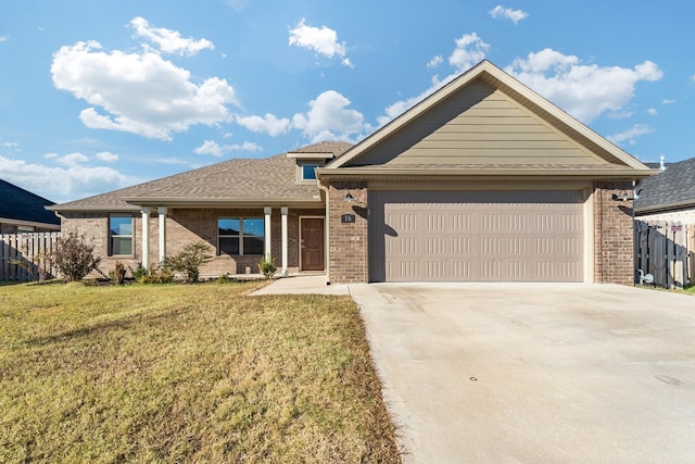 view of front of house with a front yard and a garage