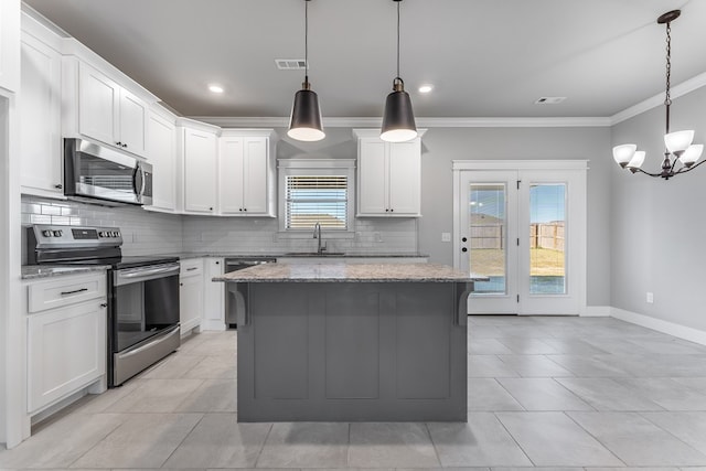 kitchen featuring white cabinets, a kitchen island, and stainless steel appliances