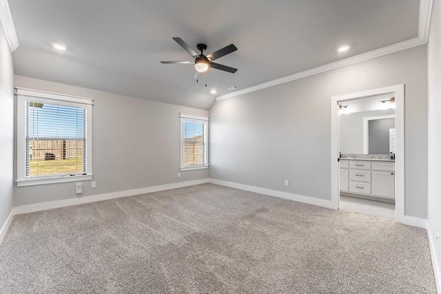 unfurnished bedroom with ornamental molding, ensuite bathroom, ceiling fan, and light colored carpet