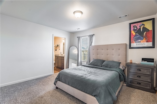 carpeted bedroom featuring ensuite bathroom