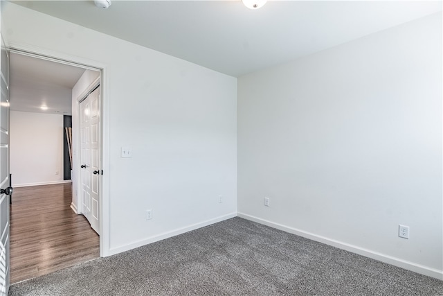 unfurnished room featuring dark hardwood / wood-style flooring