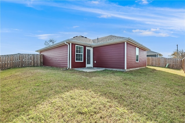 back of house with a yard