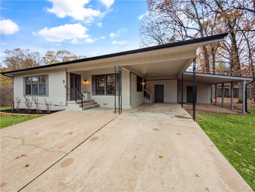 view of front of property with a front lawn and a carport