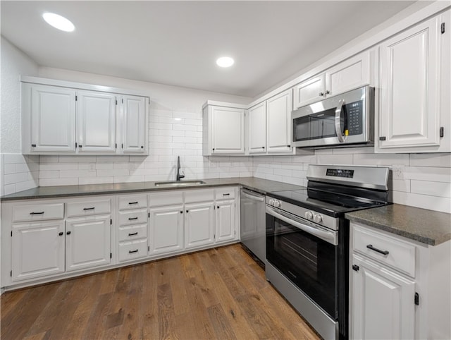 kitchen with white cabinets and appliances with stainless steel finishes