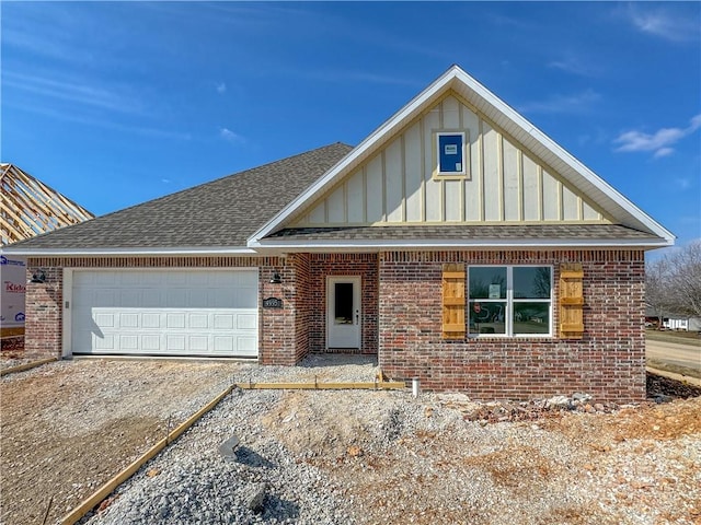 view of front of property with a garage, a shingled roof, board and batten siding, and brick siding