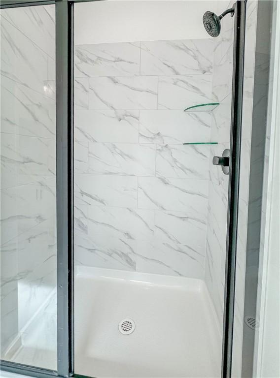 bathroom with a shower stall