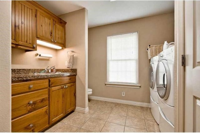 laundry area featuring light tile patterned floors and independent washer and dryer