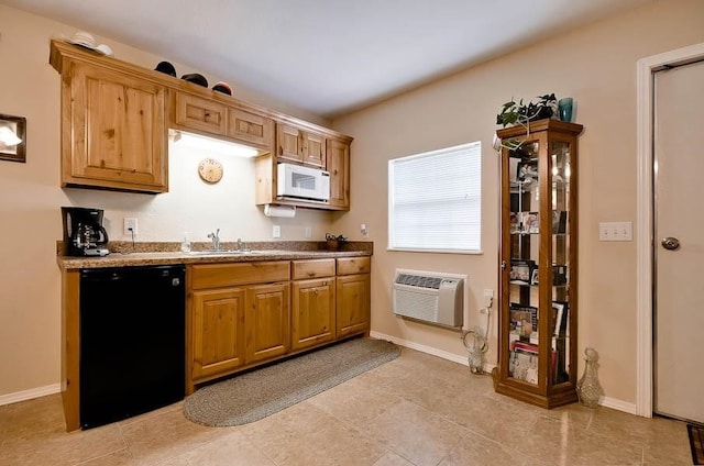 kitchen with light tile patterned floors, black dishwasher, an AC wall unit, and sink