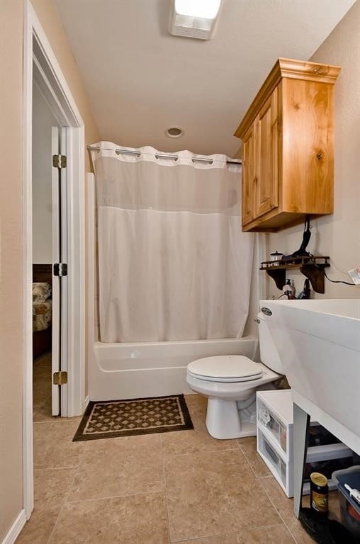 full bathroom featuring tile patterned floors, sink, shower / tub combo, and toilet