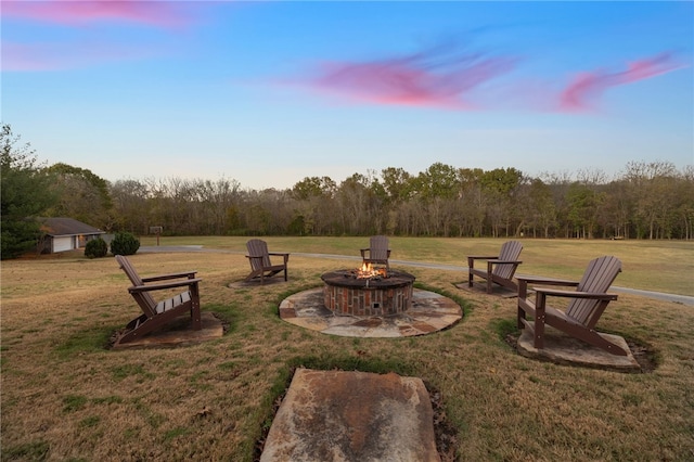 yard at dusk with a fire pit