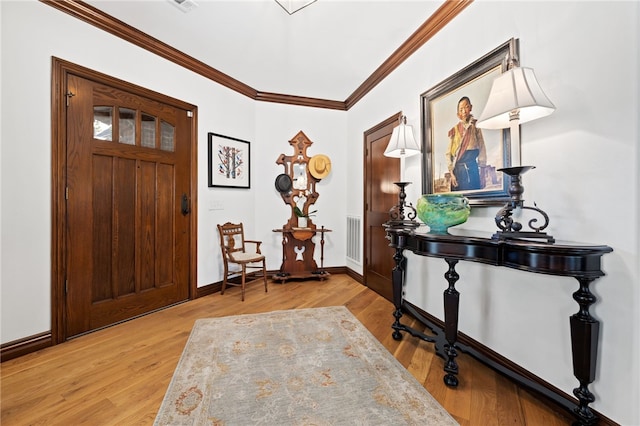 entrance foyer featuring light hardwood / wood-style flooring and ornamental molding