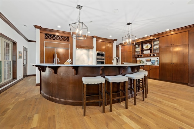 kitchen featuring light hardwood / wood-style flooring, paneled built in refrigerator, and pendant lighting