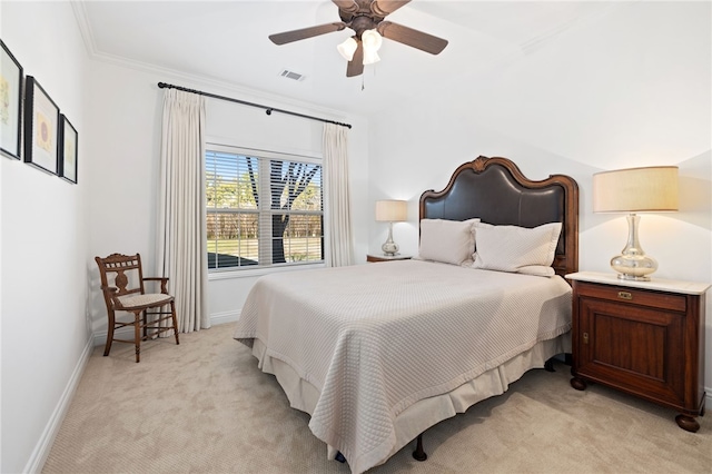 carpeted bedroom with ceiling fan and ornamental molding