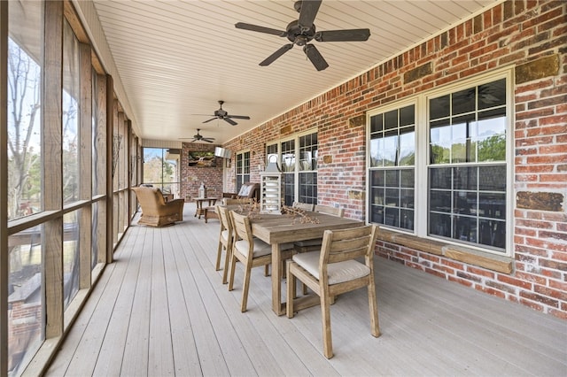 sunroom / solarium with a wealth of natural light and ceiling fan