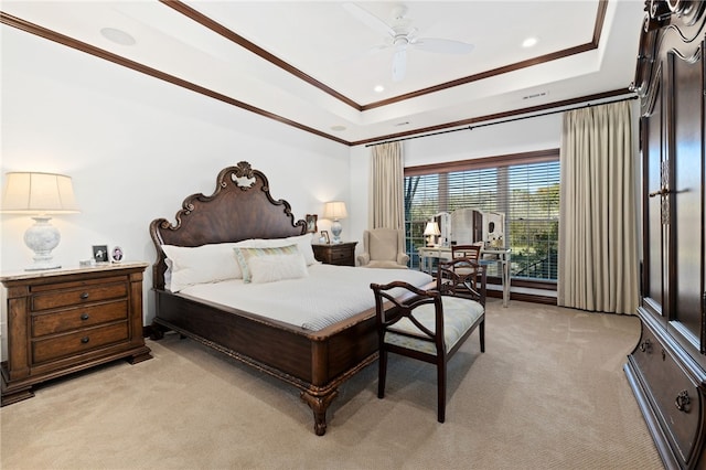 carpeted bedroom featuring a tray ceiling, ceiling fan, and ornamental molding