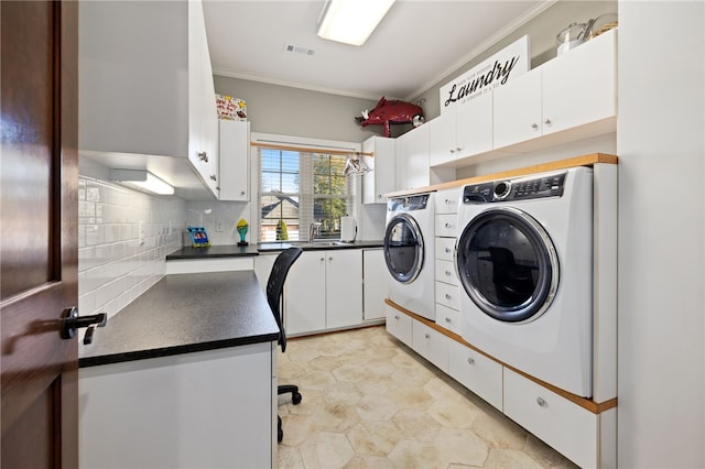 washroom with cabinets, crown molding, sink, independent washer and dryer, and light tile patterned flooring