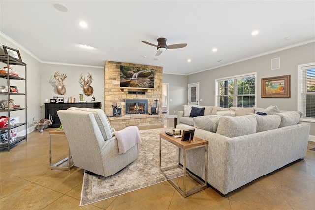 tiled living room with ceiling fan, a fireplace, and ornamental molding