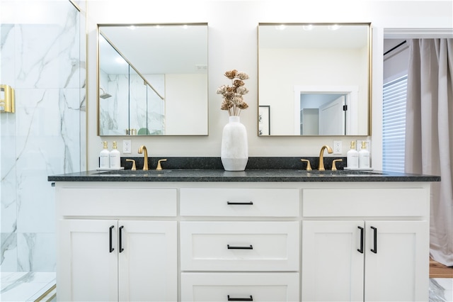 bathroom featuring vanity and a shower