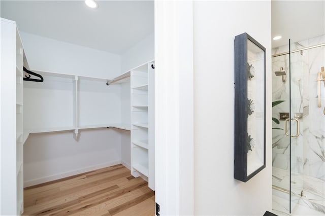 spacious closet featuring light hardwood / wood-style flooring