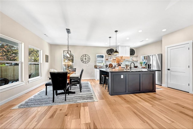 1433 S Duncan Ave, Fayetteville, AR 72701 - dining space featuring light wood-type flooring, recessed lighting, and baseboards