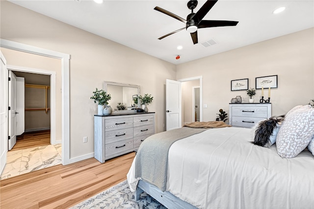 bedroom with ceiling fan and light hardwood / wood-style flooring