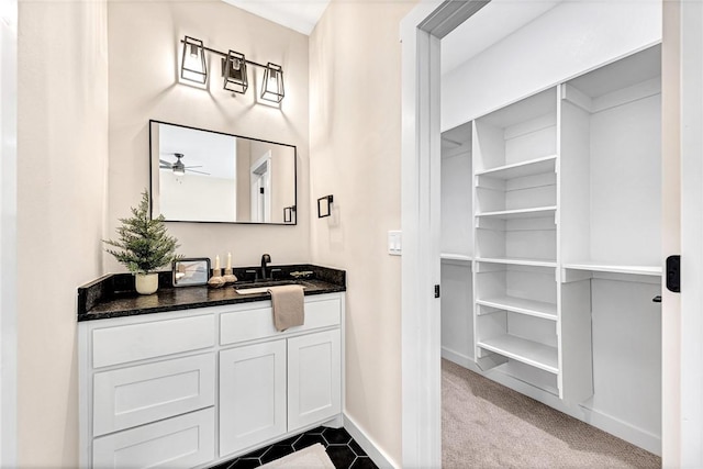 1433 S Duncan Ave, Fayetteville, AR 72701 - bathroom featuring vanity, baseboards, a ceiling fan, and a closet