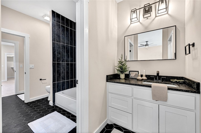 full bathroom with tiled shower / bath, vanity, toilet, and tile patterned flooring