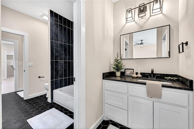 1433 S Duncan Ave, Fayetteville, AR 72701 - bathroom featuring vanity, toilet, baseboards, and washtub / shower combination