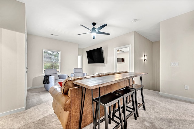 living room featuring light carpet and ceiling fan