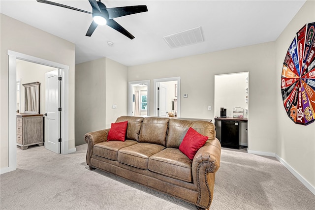 living room featuring ceiling fan and light carpet