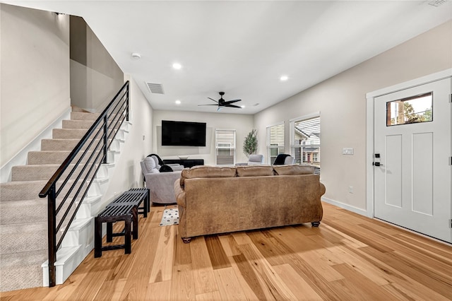 living room featuring ceiling fan and light hardwood / wood-style flooring