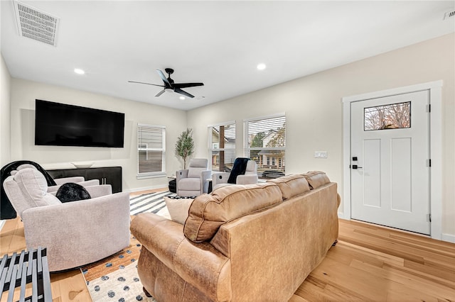 living room with ceiling fan and light wood-type flooring